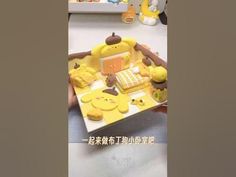 the cake is made to look like winnie the pooh and her friends are eating it