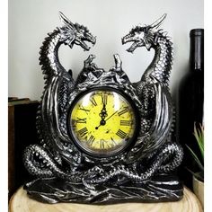 a dragon clock sitting on top of a wooden table