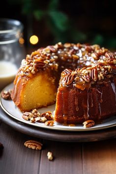 a bundt cake on a plate with pecans around it