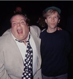 two men standing next to each other with their mouths open