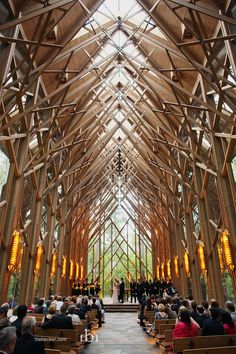 the inside of a church with people sitting in pews