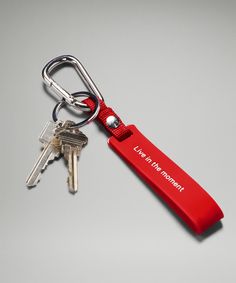 a red keychain with two keys attached to it