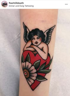 a tattoo on the arm of a woman with an angel and flower in her heart