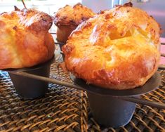 three muffins sitting on top of each other on a metal tray next to a window