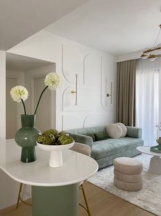 a living room filled with furniture and a white table