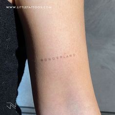 a woman's arm with the word wonderland written on it