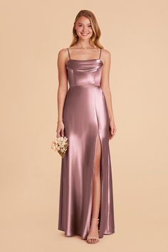 a bridesmaid in a long, satin gown with side slit and spaghetti straps