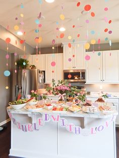 a baby shower party with confetti hanging from the ceiling