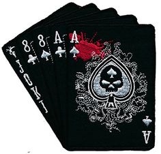 four black playing cards with white and red designs on the front, one has an ace symbol