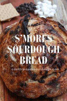 a loaf of sourdough bread sitting on top of a wooden cutting board