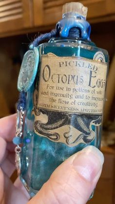 a person holding up a bottle with an octopus on it's label in their hand