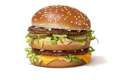 a cheeseburger with lettuce, pickles and mayonnaise on it