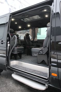 the interior of a van with its doors open and seats in place for people to sit