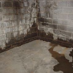 a dirty room with some water on the floor and walls that have been stripped off