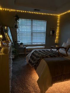 a bedroom with lights on the walls and a bed