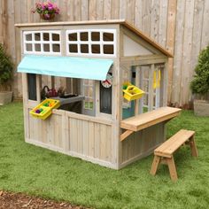 a child's play house with a blue awning