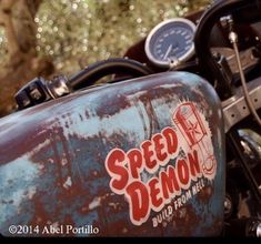 an old motorcycle with the speed demon sticker on it