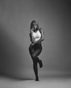 a black and white photo of a woman in tights