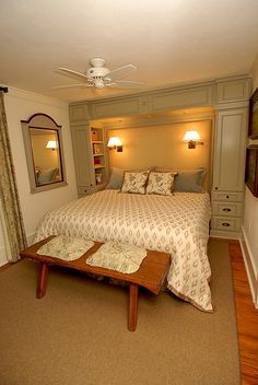 a bedroom with a large bed and two lamps on either side of the headboard