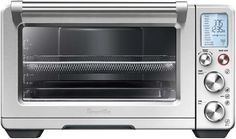 a toaster oven with the door open and timers on it's side