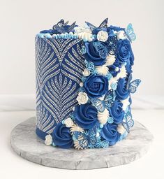 a blue and white cake decorated with flowers