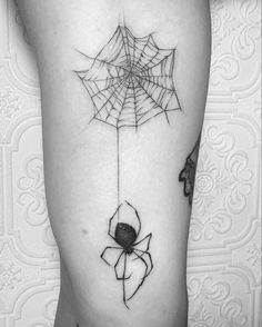 a black and white photo of a spider web tattoo