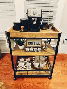 a coffee cart with cups and plates on it