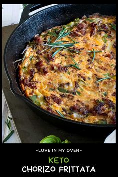 an omelet in a cast iron skillet with herbs on top