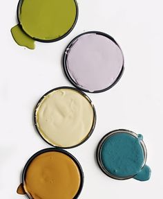 four different colors of paint sitting on top of each other