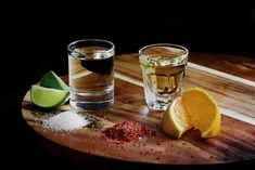 two shot glasses filled with alcohol on a wooden table