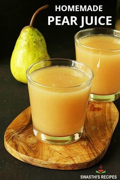 two glasses of pear juice on a wooden plate