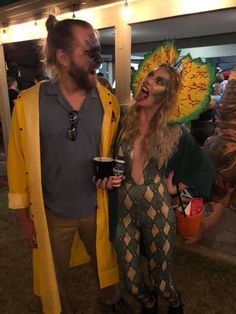 a man and woman dressed in costumes standing next to each other