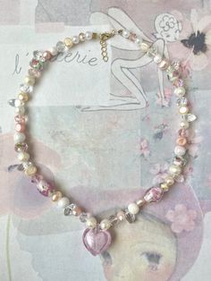 super cute fairycore inspired baby pink heart necklace ️🌸 made with murano glass heart pendant, fresh water pearl beads and rondelle crystals beads <3 necklace is approximately 16 inches but has a chain at the end to adjust length!  Canadian Orders 🇨🇦  this order is eligible for free shipping through untracked lettermail however I cannot refund/replace lost or stolen items with no tracking number due to Etsy's policies, so please keep that in mind when selecting free shipping. thank you! Cheap Beaded Heart Necklace, Cute Pearl Jewelry With Heart Beads, Cute Beaded Necklaces With Heart Beads For Valentine's Day, Cute Pink Pearl Necklace, Dainty Pink Beaded Necklaces With Heart Beads, Dainty Pink Beaded Necklace With Heart Beads, Handmade Pink Heart Crystal Necklaces, Pink Heart-shaped Pearl Necklace, Y2k Heart-shaped Necklace For Gifts