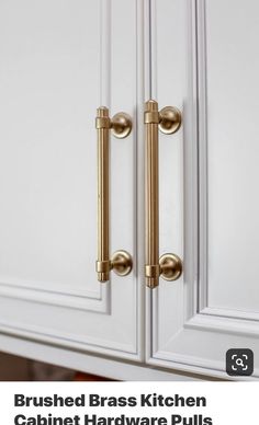 a close up of a door handle on a white cabinet with gold handles and knobs