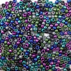 many different colors of beads on a white surface