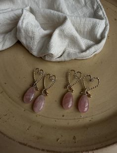 The heart-shaped design, crafted from gold-plated beaded wire, symbolizes the profound connection love brings. Soft pink rose quartz stones, renowned for their calming and loving energy, are thoughtfully chosen to inspire balance and peace within. Each pair is  handmade with care, ensuring a meaningful touch of love in your life. These earrings not only represent the crystal of eternal love but also support unconditional love in all aspects of life. Let the gentle energy of rose quartz open your Wire Rose, Loving Energy, Love Connection, Rose Quartz Earrings, Rose Quartz Stone, Chakra Balancing, Quartz Rose, Quartz Earrings, Handmade Gold