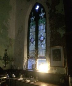 an old church with stained glass window and sink in the foreground, light coming from behind