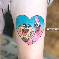 a person with a tattoo on their arm holding a piece of food in the shape of a heart