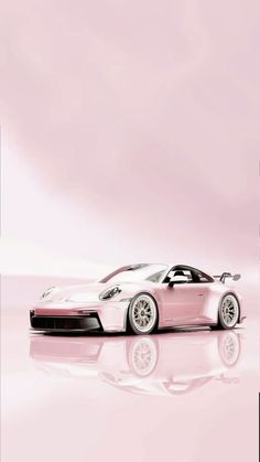 a pink sports car parked in front of a mirror