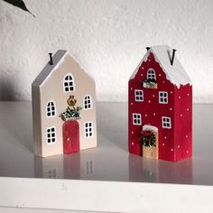 three small houses sitting on top of a table