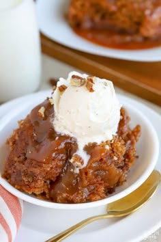 pumpkin pudding cake in a white bowl with ice cream on top