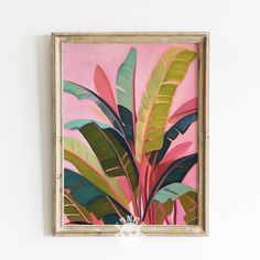 a painting hanging on the wall next to a plant