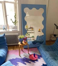 a living room filled with blue couches and chairs