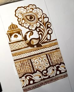 an intricately designed piece of paper with gold and white designs on the inside of it