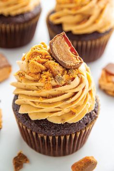 chocolate cupcakes with peanut butter frosting and candies on the top one