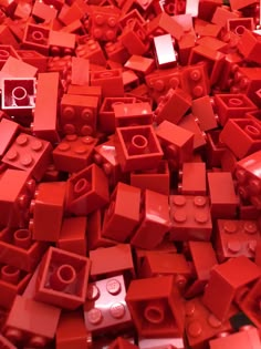 a pile of red legos sitting on top of each other