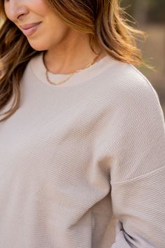 The feel of a sweatshirt with a chic vibe! The subtle woven textured look with the relaxed sleeves can be either dressed up or down to match your style! We love that this can be worn with shorts for the warmer months or denim, joggers, or our Betsey's Jeggings for the cooler ones. Chilly? Add a vest or jacket with ease! Simply add your favorite accessories to elevate this piece. Heather Sweatshirt With Ribbed Cuffs, Beige Relaxed Fit Sweatshirt With Ribbed Cuffs, Cream Relaxed Fit Fleece Top, Cozy V-neck Sweatshirt With Ribbed Cuffs, Soft-washed Beige Crew Neck Top, Denim Joggers, Boutique Shop, Jeggings, Ruffle Trim