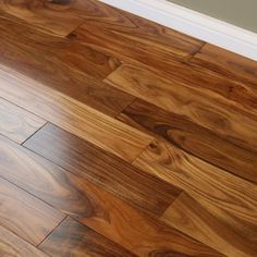 a wooden floor with white trim on it