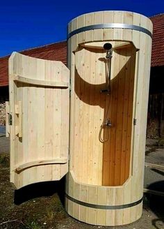 a large wooden sauna sitting on top of a dirt field