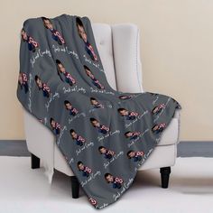 a couch with a blanket on it that has an image of a man and woman